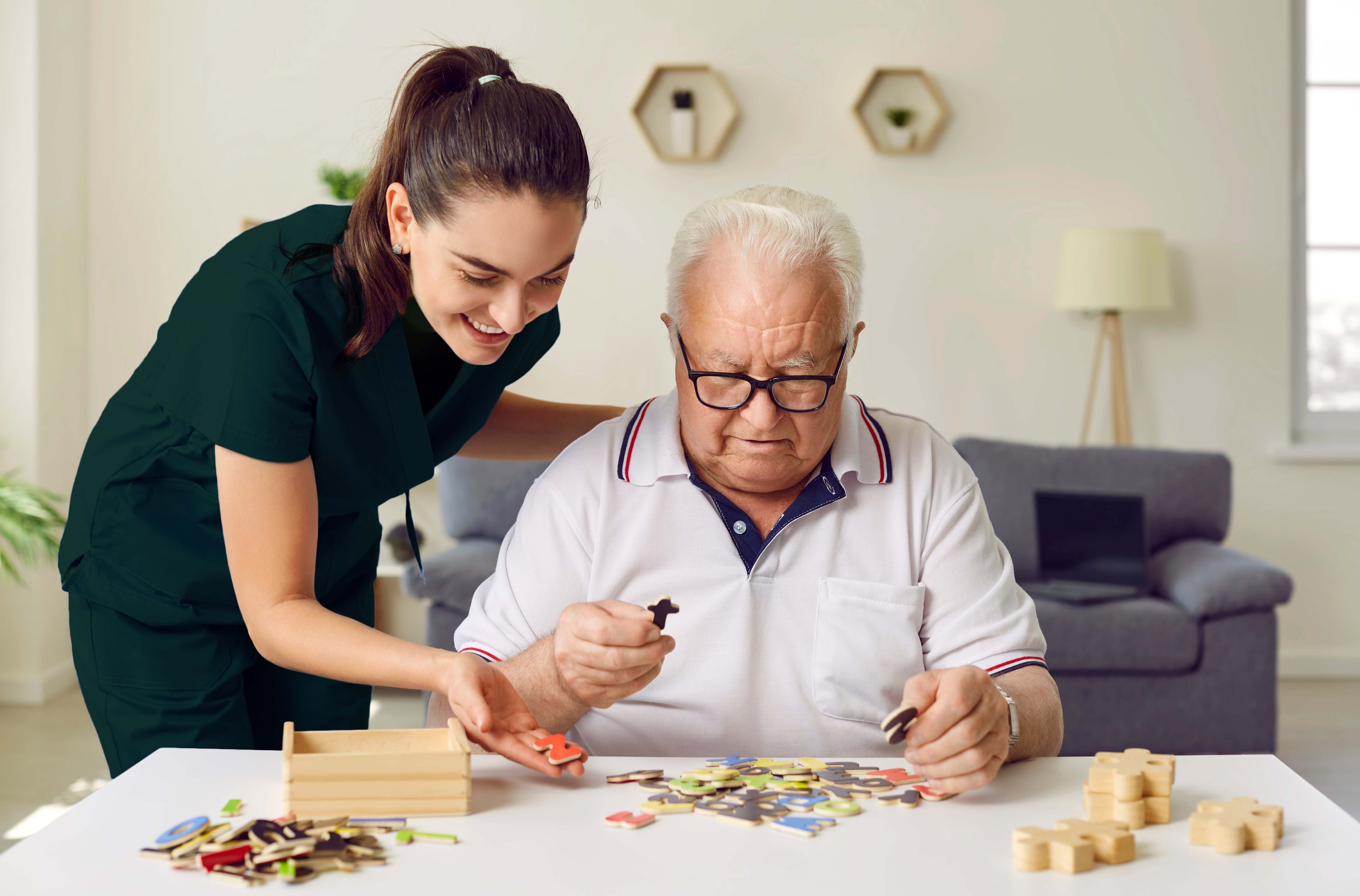 a woman helping an older man solve a puzzle