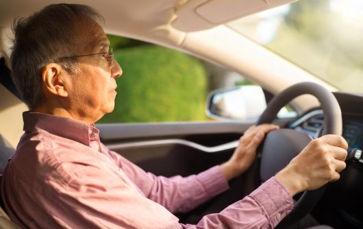 Senior man driving car