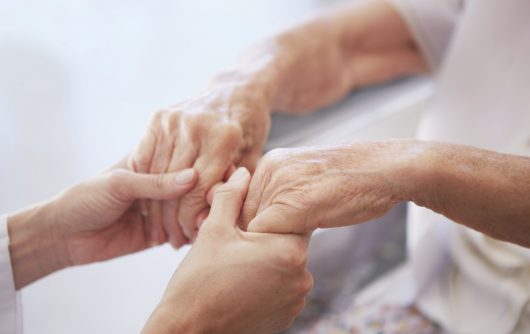 Holding hands - Symbolizing care and support for a patient.