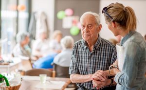 Senior man holding caregiver's hand