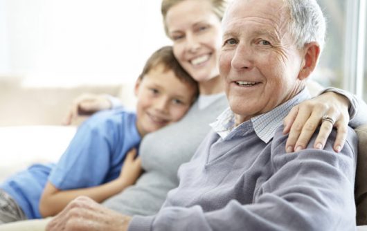 grand-père avec sa fille et son petit-fils souriant