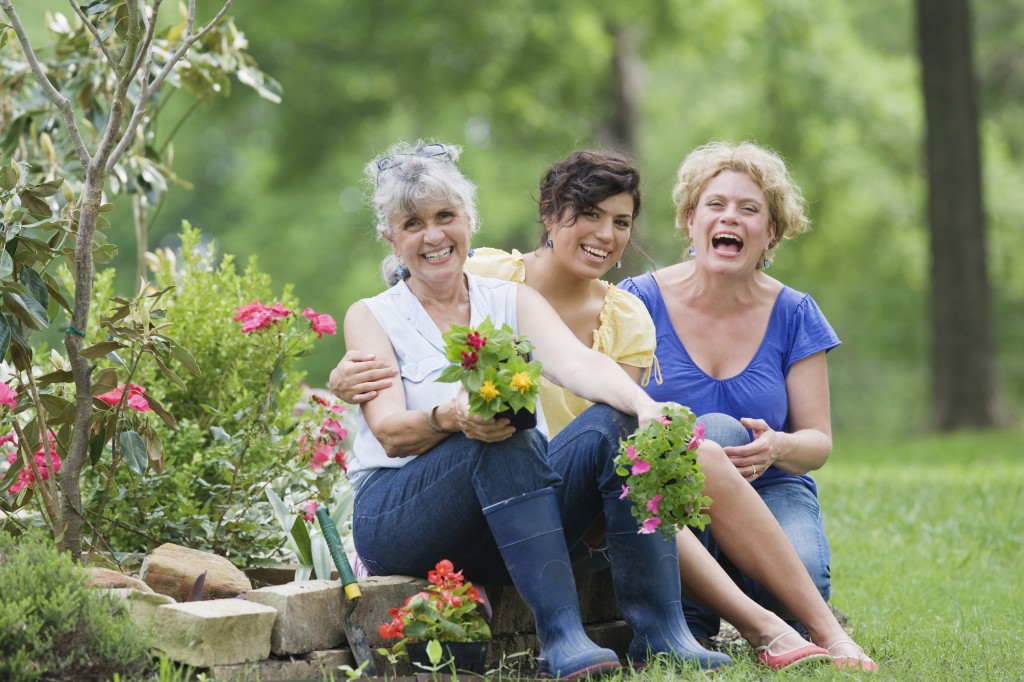 Senior women with young woman gardening
