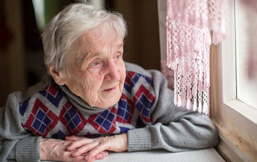 Senior looking out the window