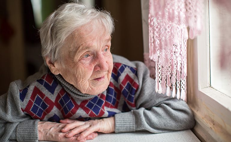 Senior looking out the window