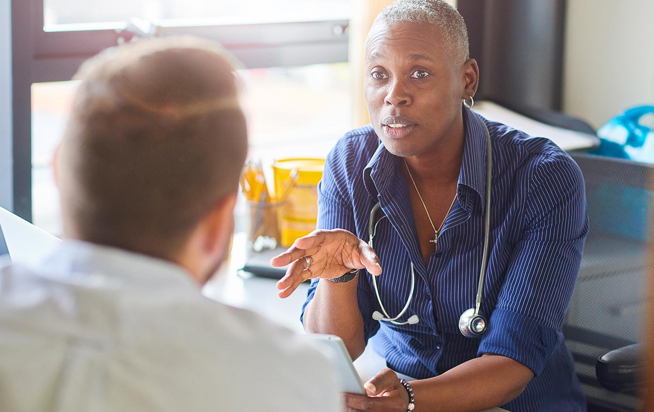 Female doctor talking to male patient