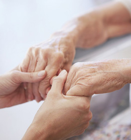 Senior hands and young hands holding