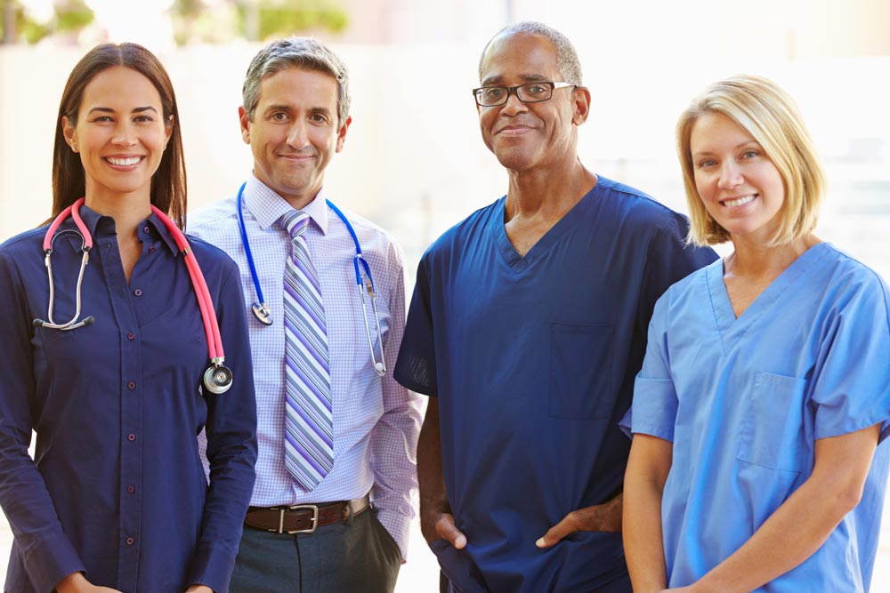 A group of medical professionals standing together and smiling for the camera.