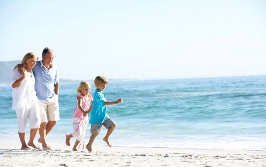 Grandparents and children at the beach