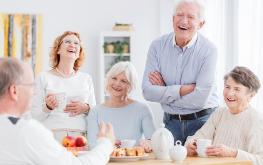 group of seniors eating and laughing