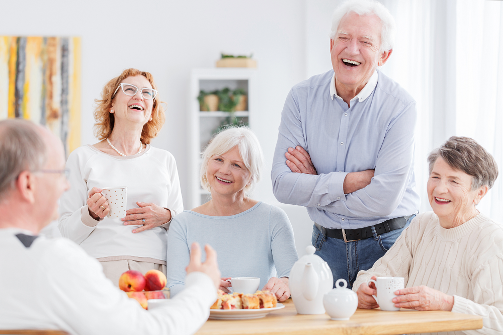 group of seniors eating and laughing