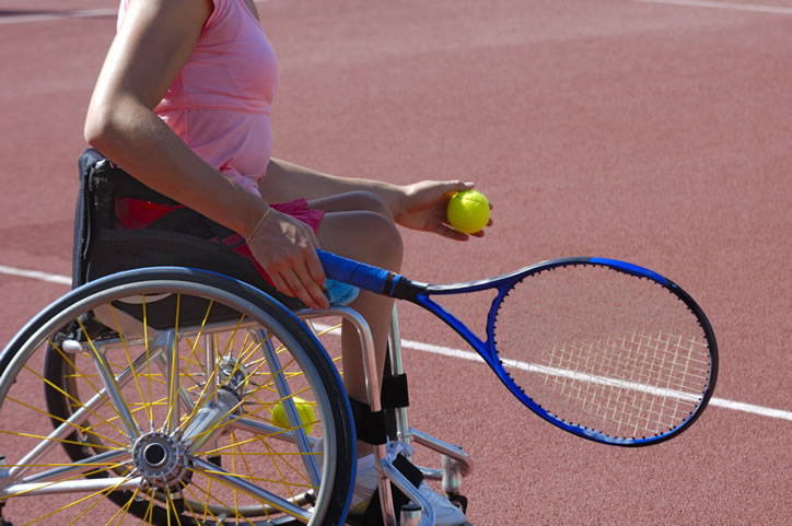 Woman in wheelchair playing tennis