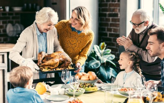 Family enjoying thanksgiving dinner with grandparents