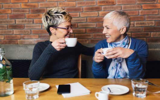 Two women in café smiling