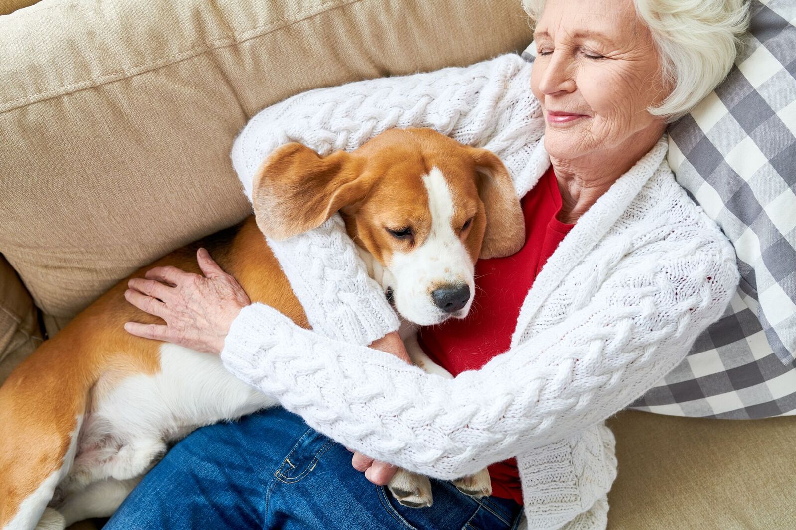 senior woman napping with dog