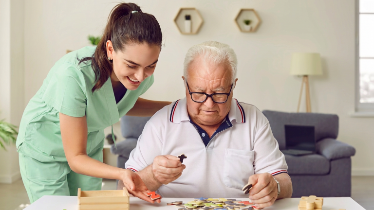 A nurse solving puzzles with an elderly patient
