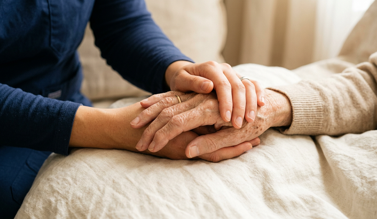 A pair of young hands holding a pair of old hands showing comfort and care.