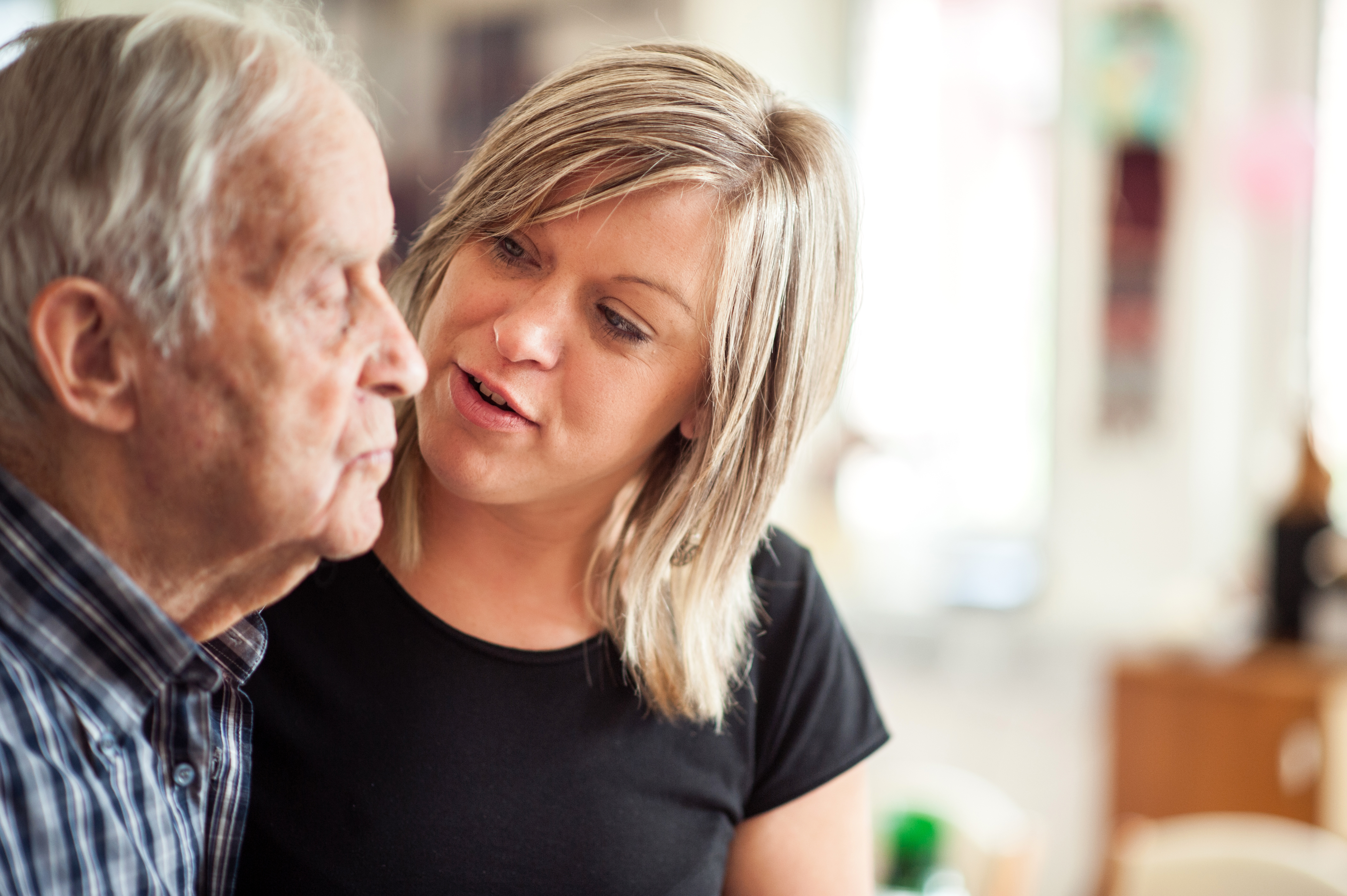 Young woman talking to senior man