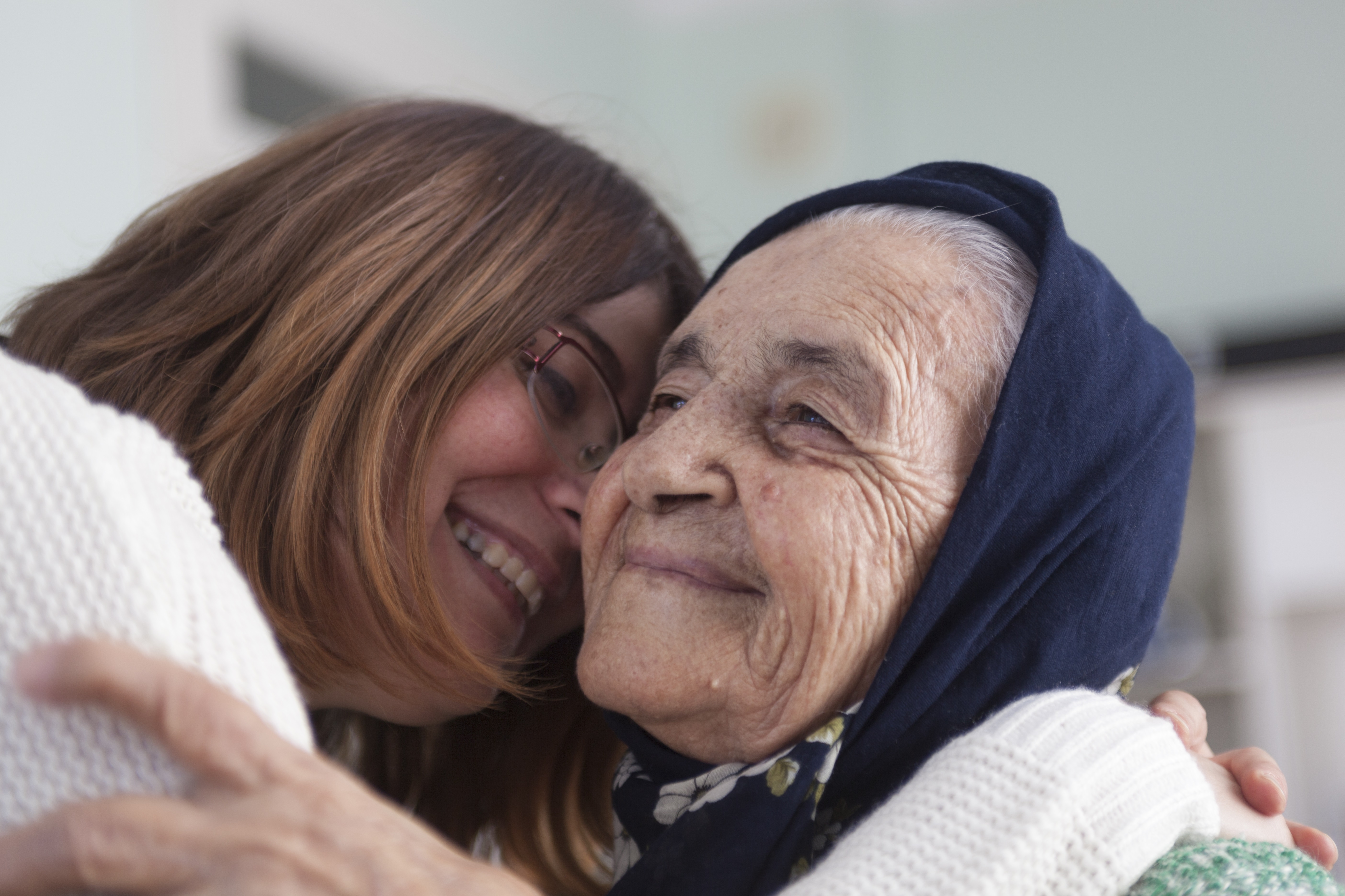 young woman hugging senior woman