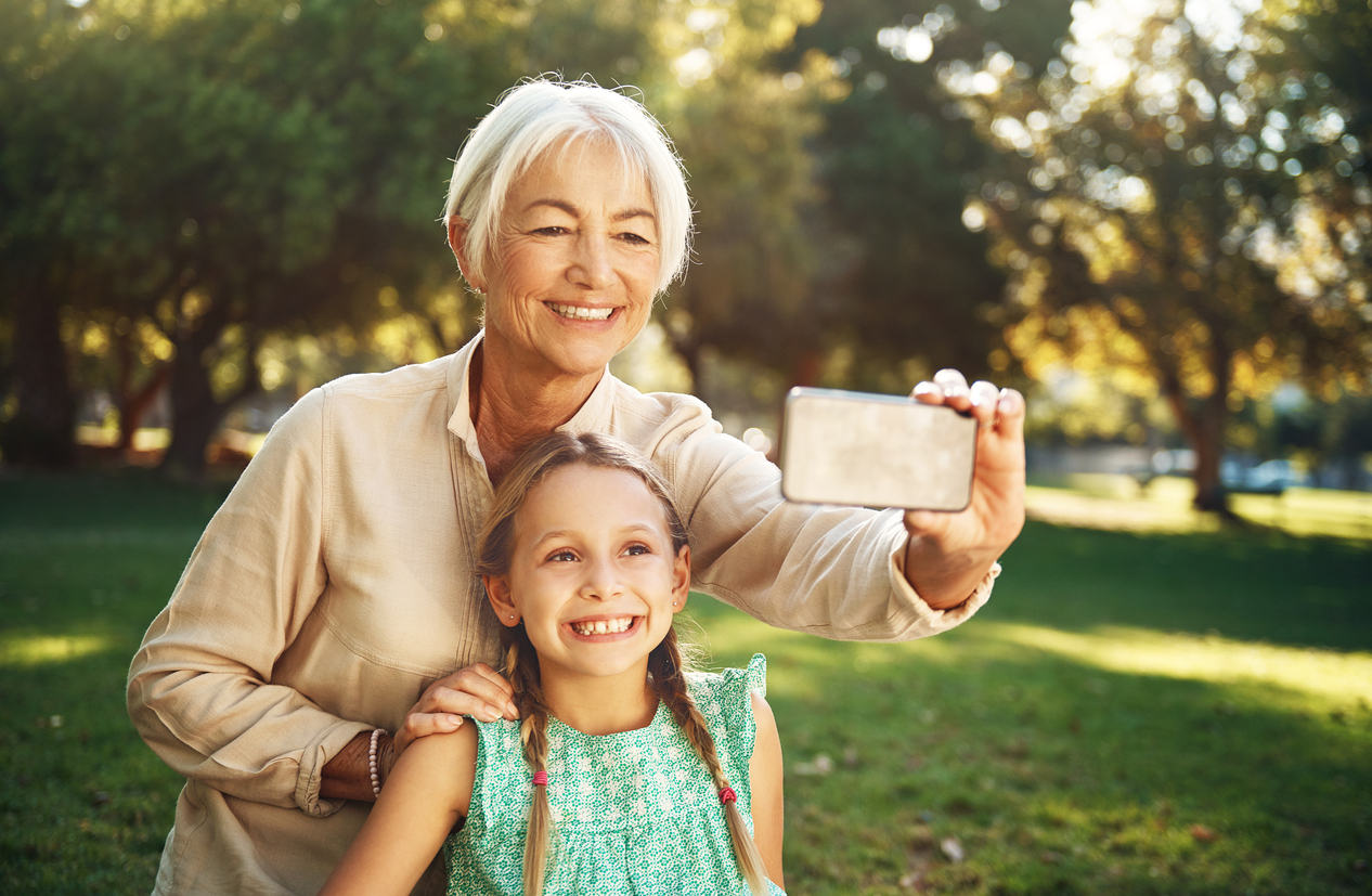 senior woman and grandchild taking selfie