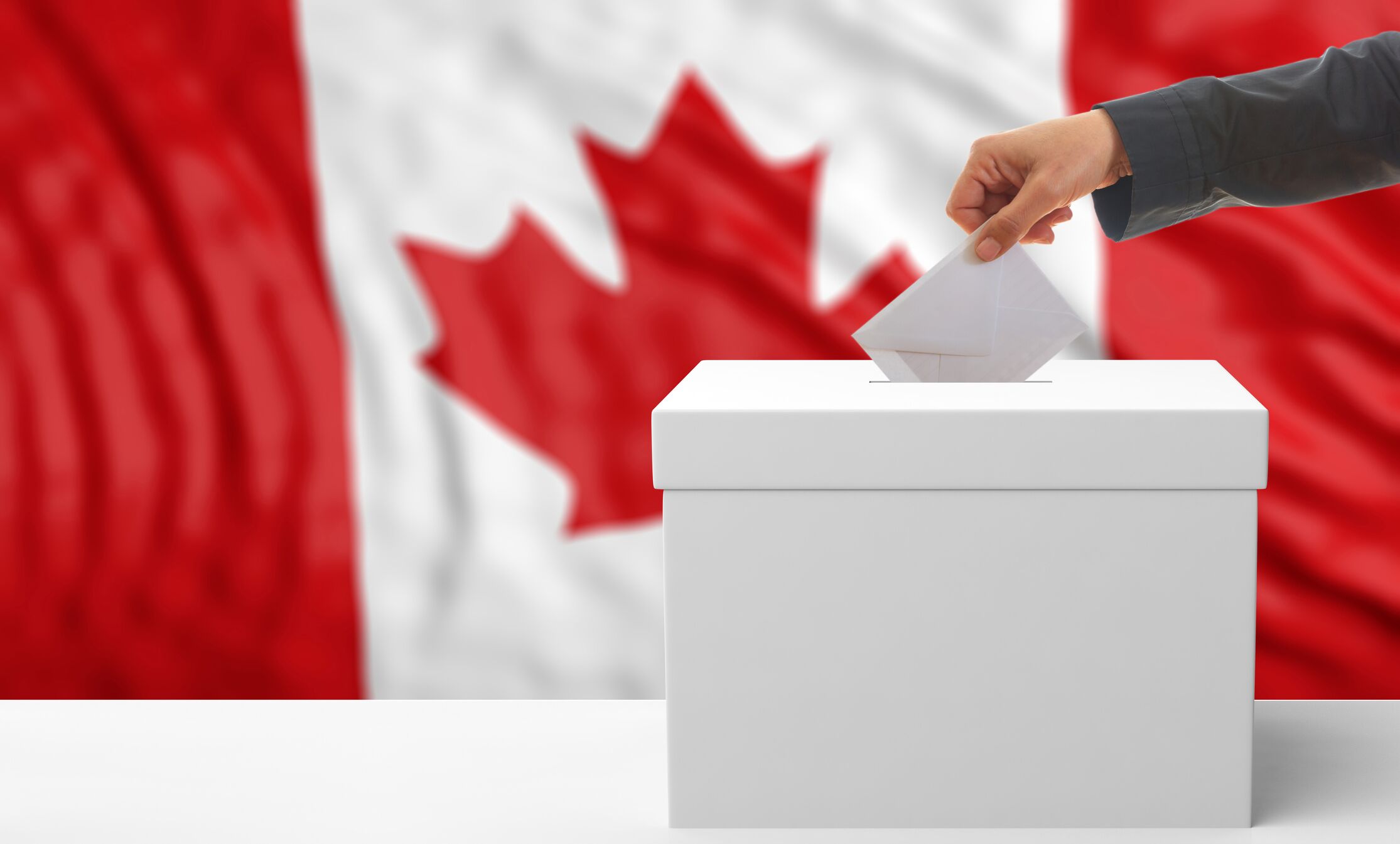 Person putting a ballot into a voting box.