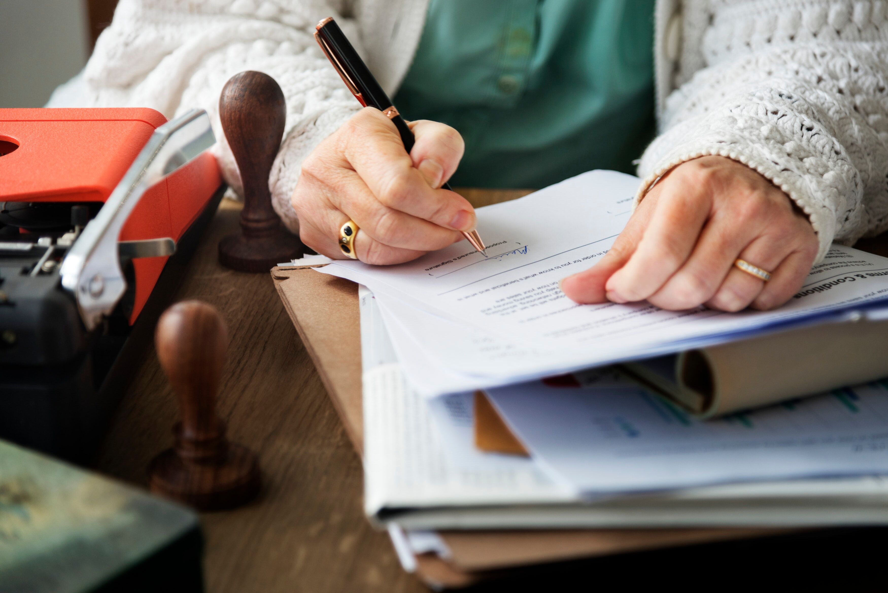 senior woman signing document