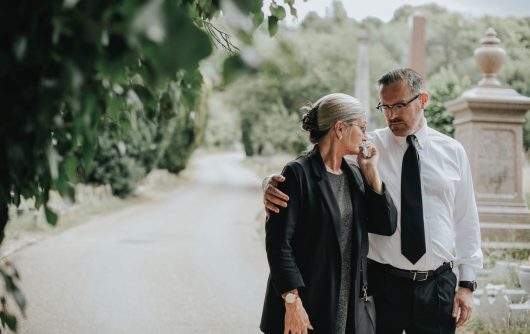 Couple embracing at cemetery