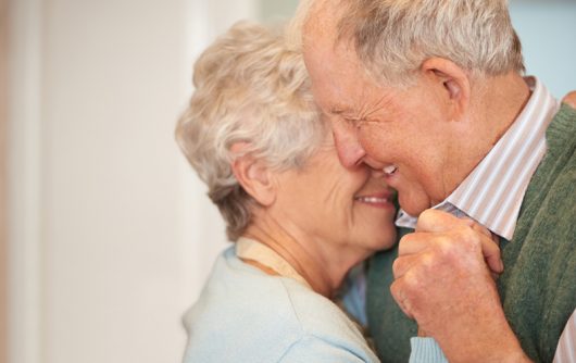 Senior couple smiling and embracing