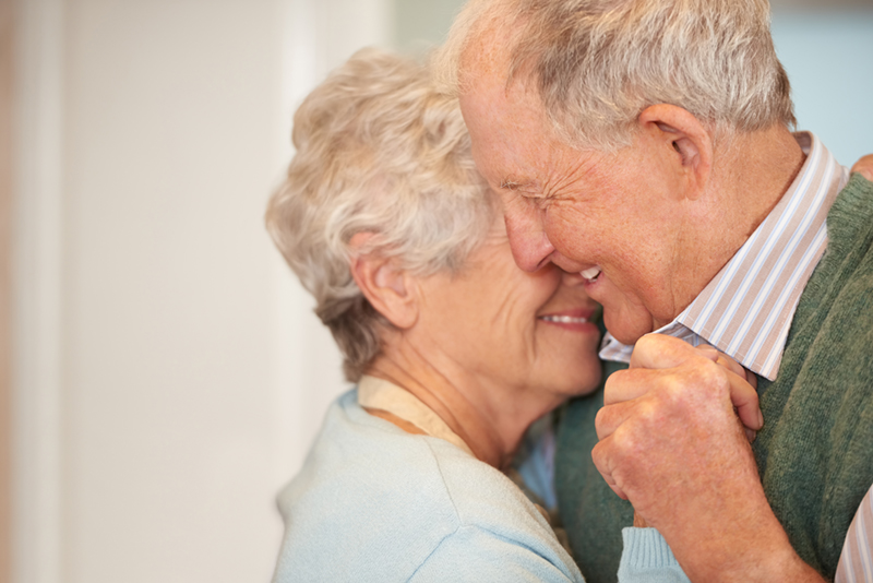 Senior couple smiling and embracing