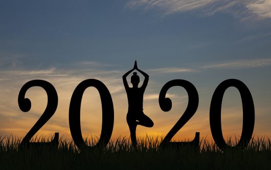 Woman doing yoga with 2020 in big font