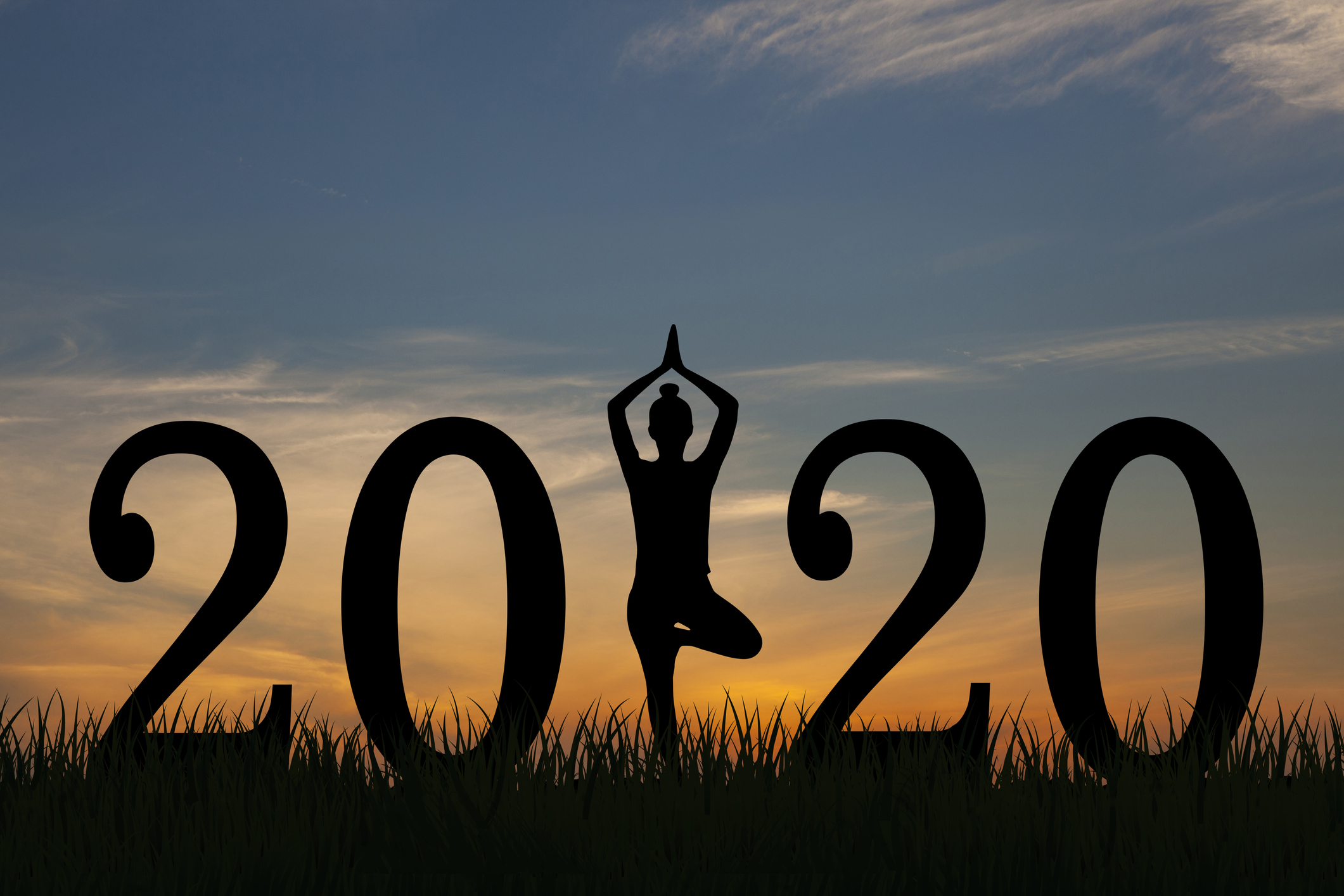Woman doing yoga with 2020 in big font