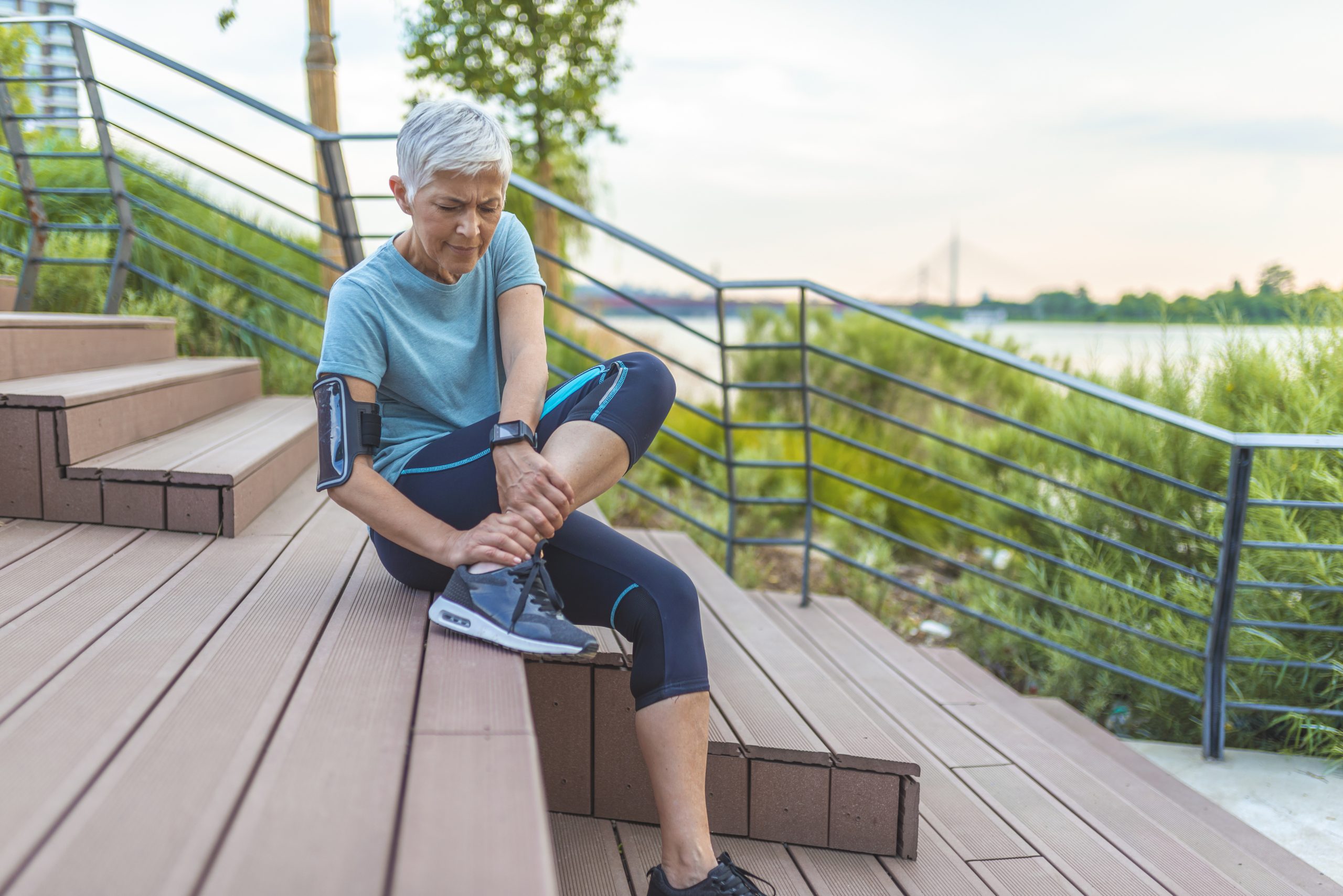 Senior woman athlete stretching before run