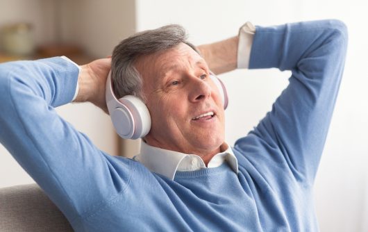 Senior man listening to headphones