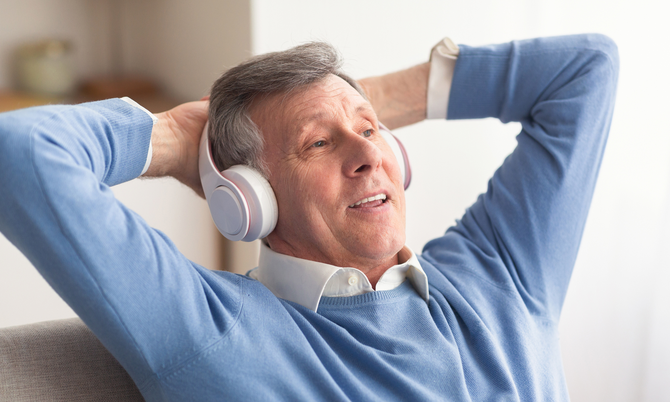 Senior man listening to headphones