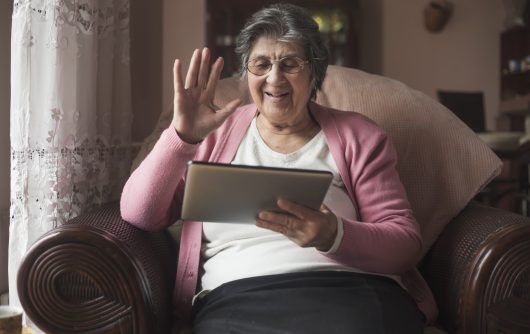 Senior woman at home using iPad