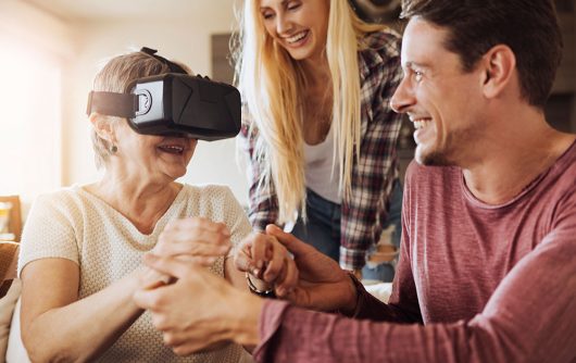 Senior woman and family using VR goggles