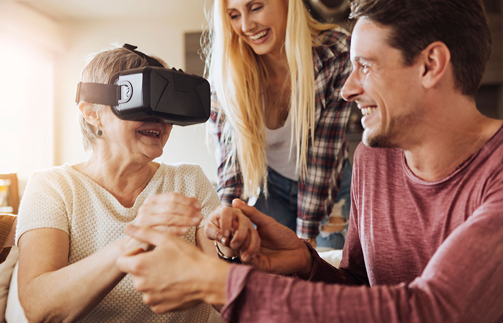 Senior woman and family using VR goggles