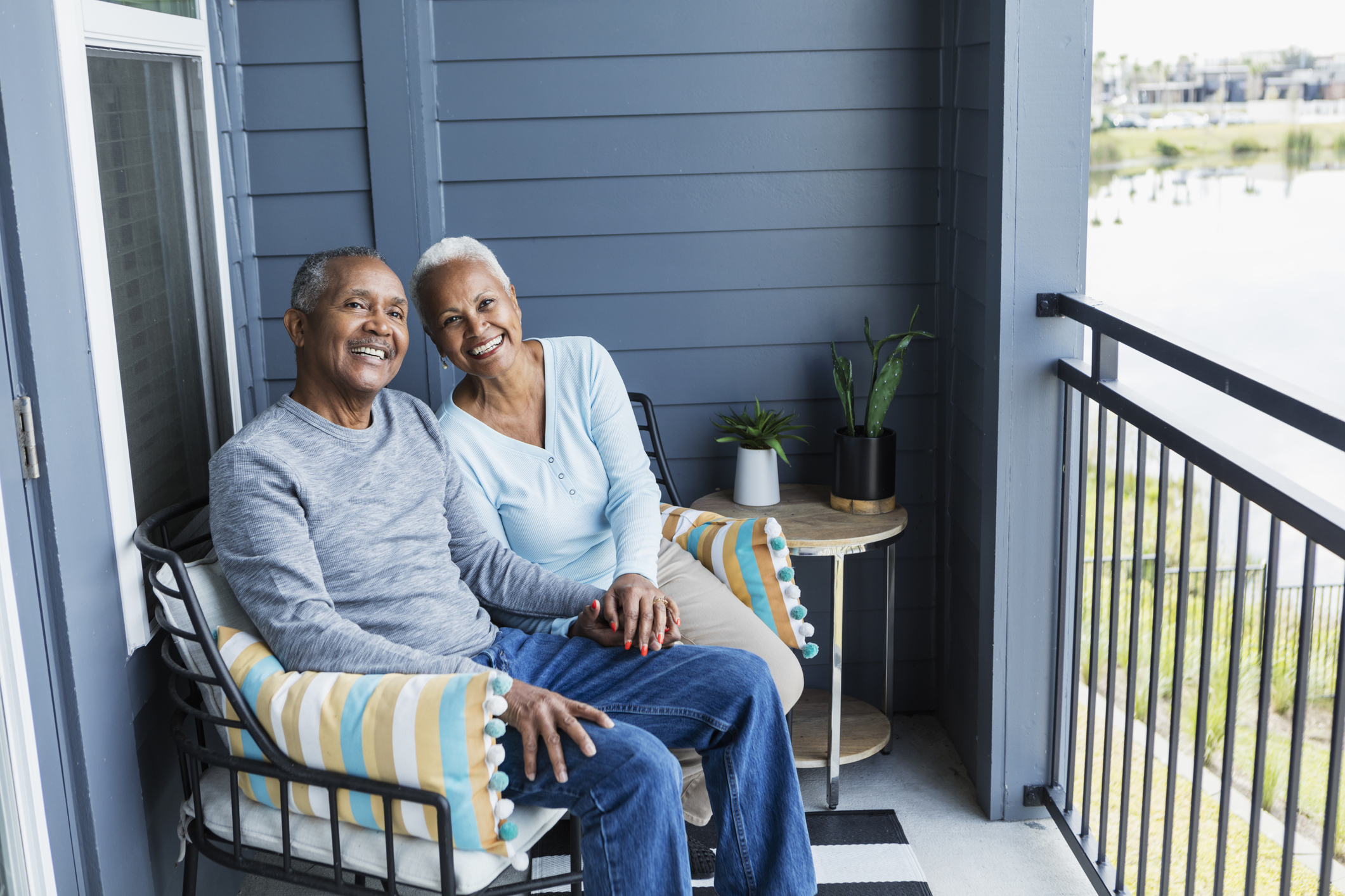 Senior couple smiling sitting on porch