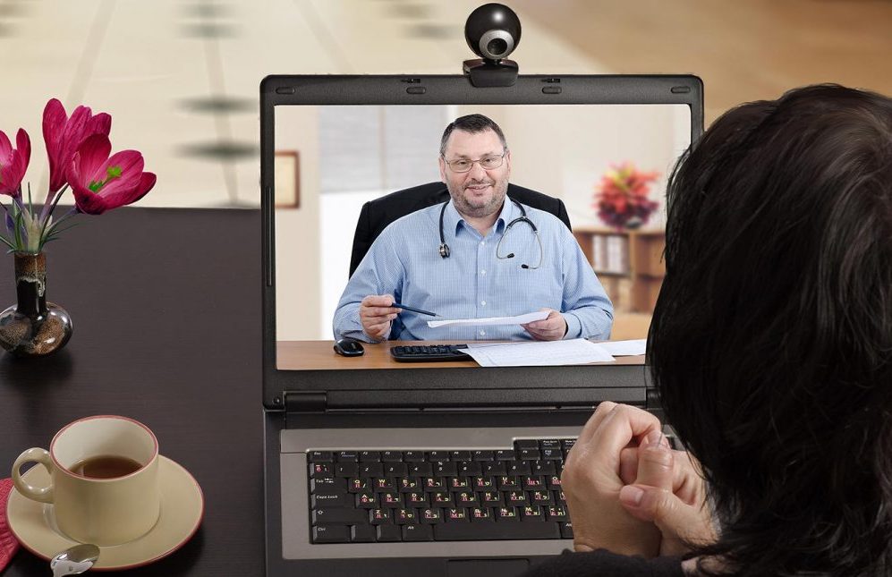 Person looking at laptop to virtual call with doctor