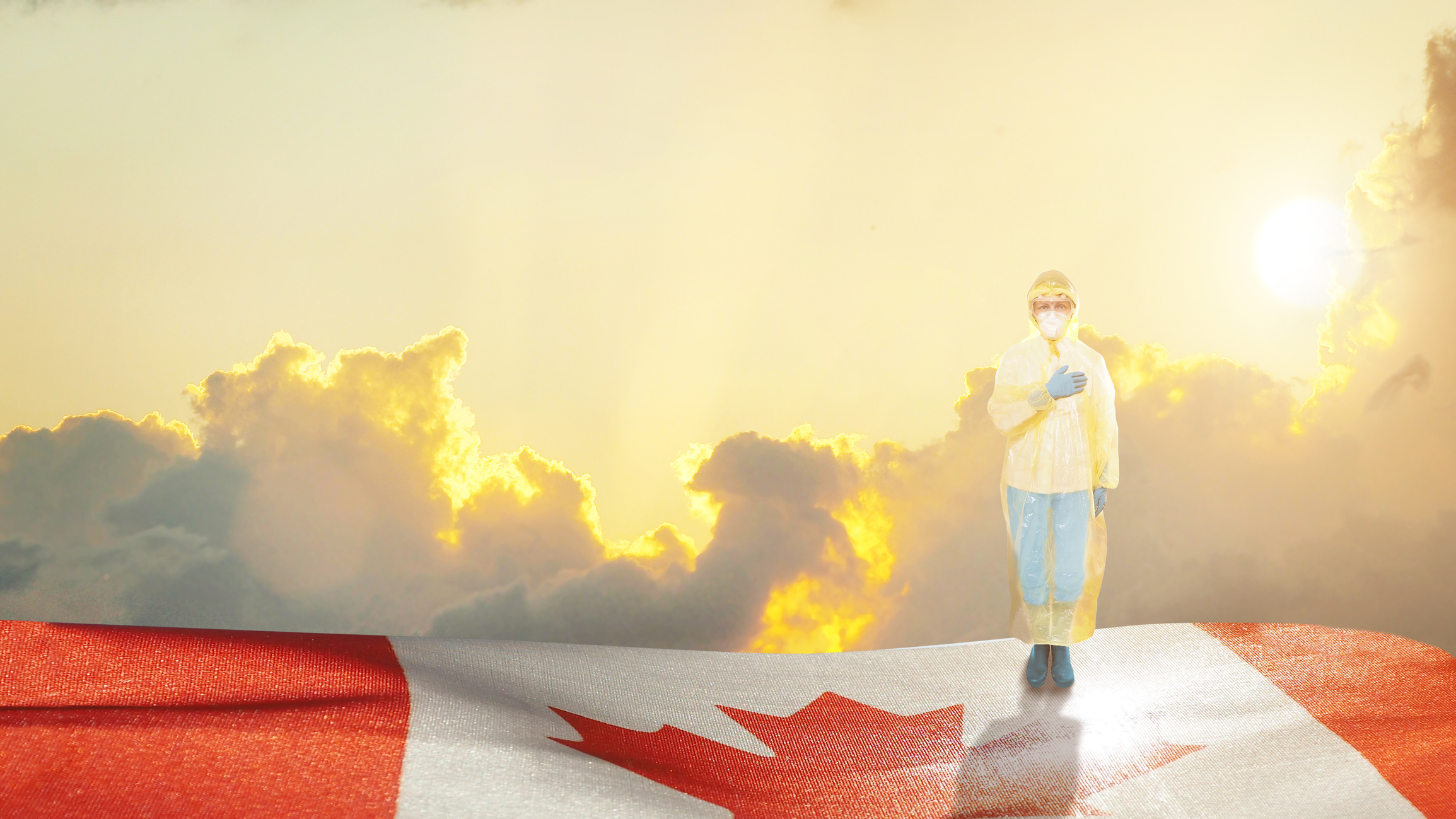 Medical worker in personal protective gear standing on Canadian flag with hand to chest