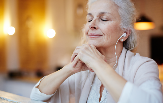 elderly woman listening to earbuds