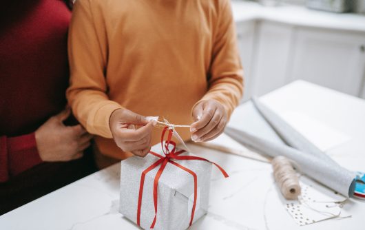 two people wrapping a gift