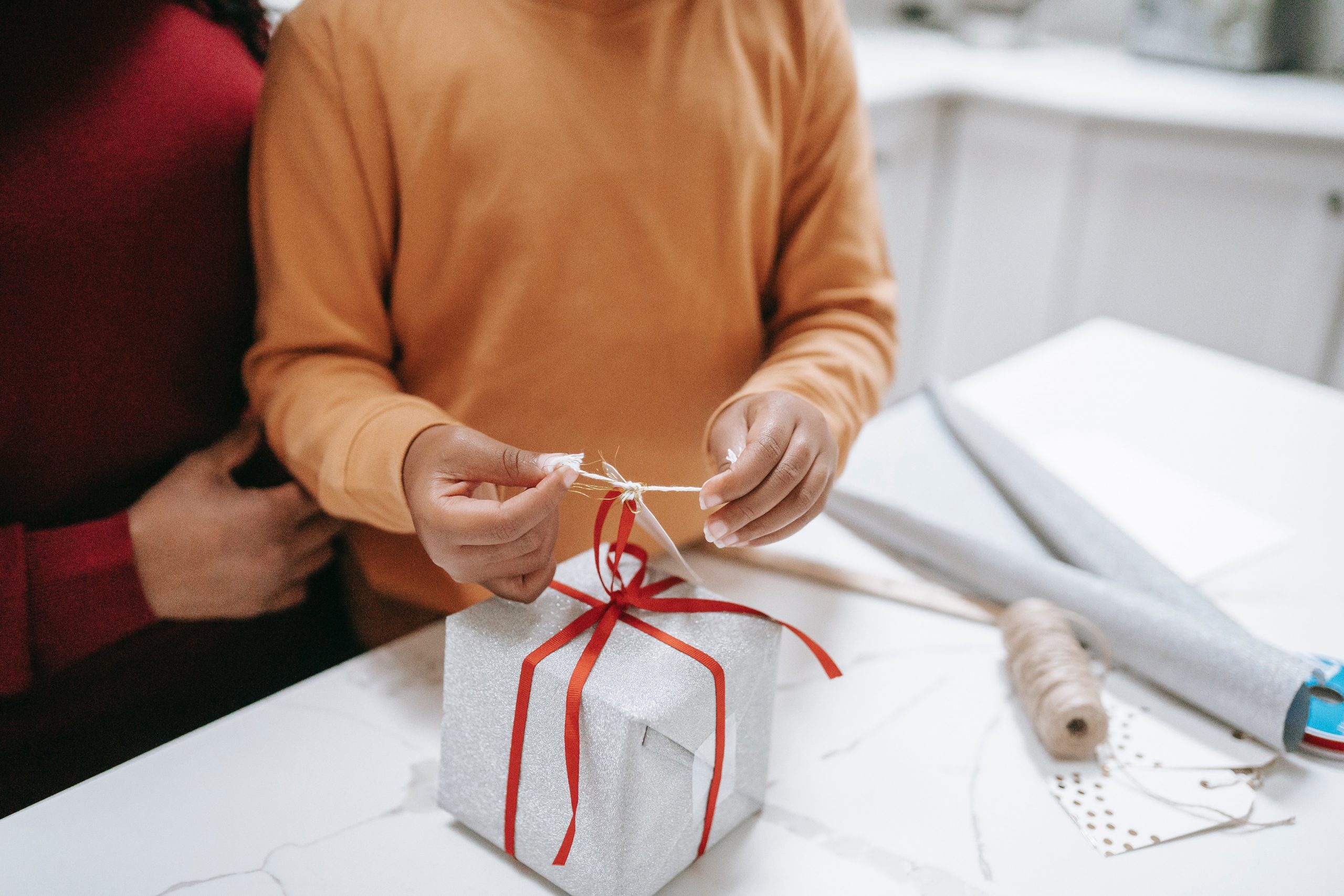 two people wrapping a gift