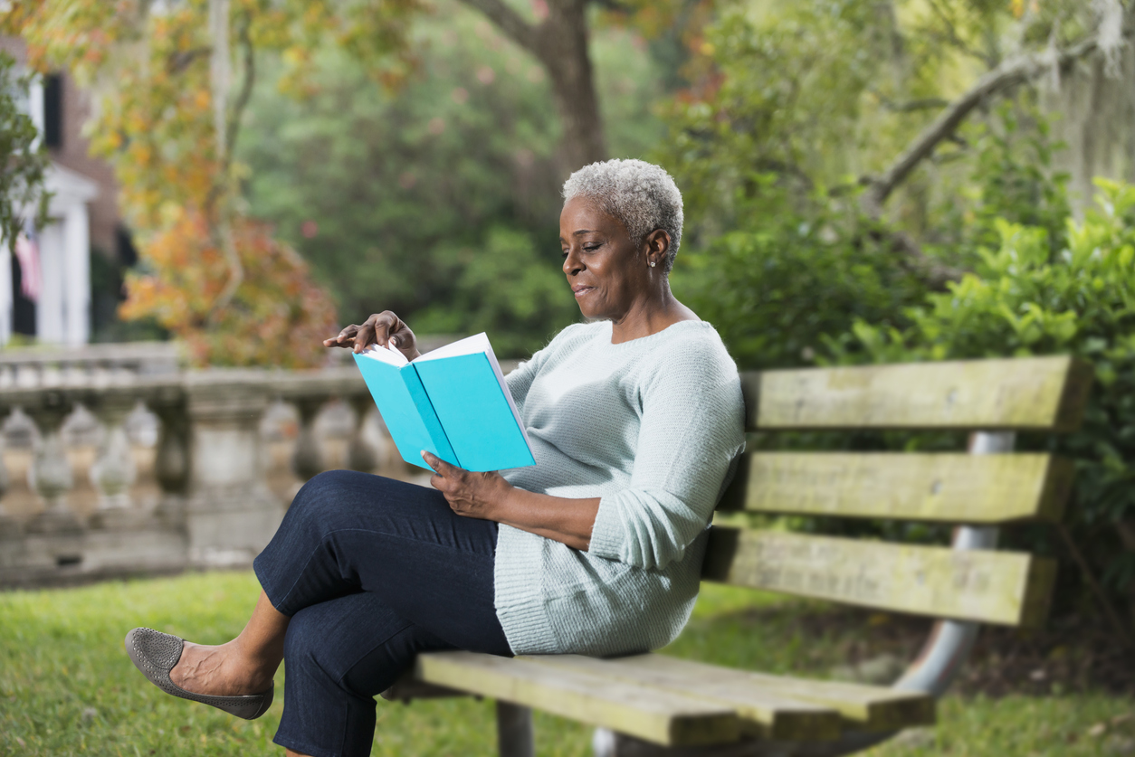 Senior black woman reading a book