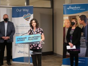 Registered Nurse Melissa Bryen stands and speaks behind a podium labeled 'Stronger Ontario'.