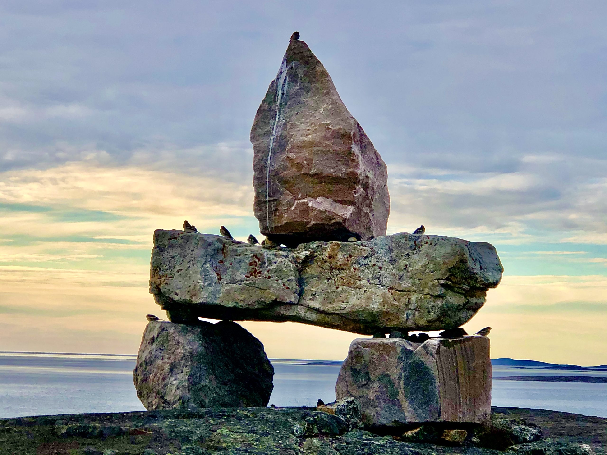 Inuqchuk overlooking water at sunrise