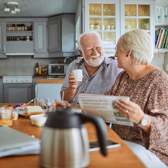 Senior couple at home enjoying breakfast