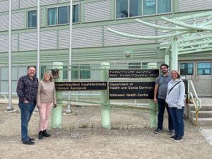 Group photo in front of sign