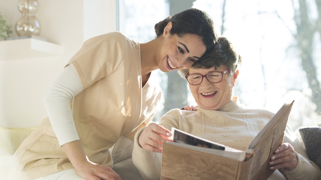 Smiling senior woman watching photobook