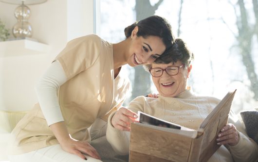 Smiling senior woman watching photobook