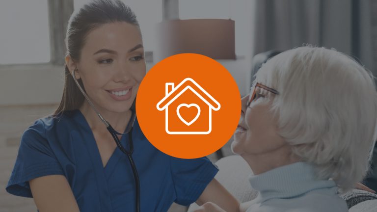 A nurse attentively converses with an elderly woman, using a stethoscope to provide medical care.